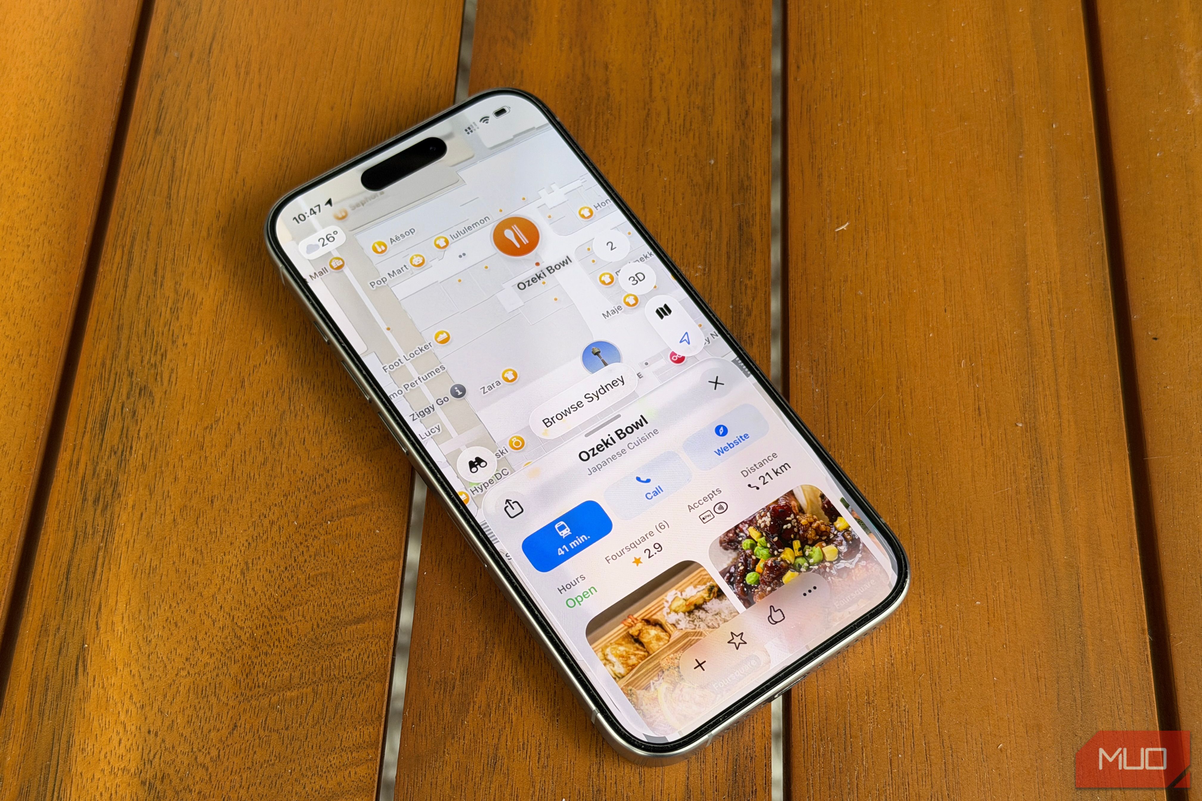 iPhone on a table with a restaurant visible on Apple Maps-2