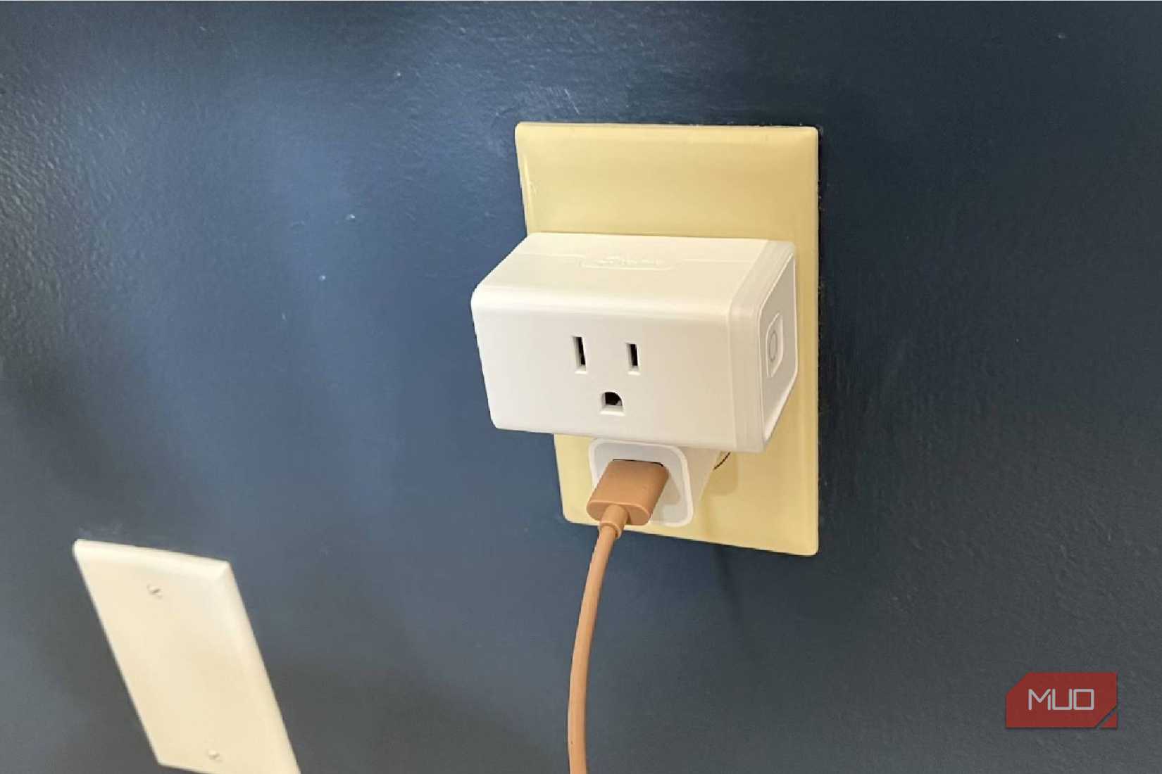 A Kasa Mini Smart Plug plugged into a wall outlet.