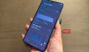 A hand holding a OnePlus 15 showing the battery usage page.