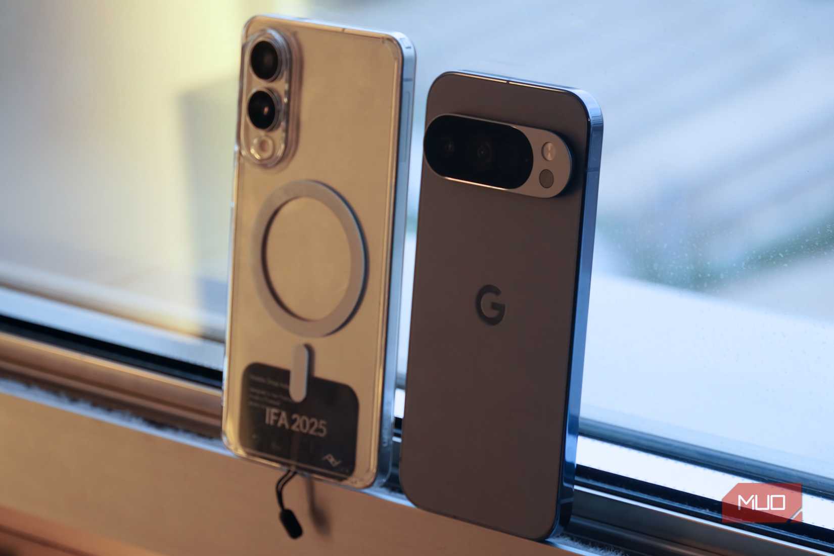 Qi2 with a case on a Galaxy phone next to a Pixel with Qi2 built-in.