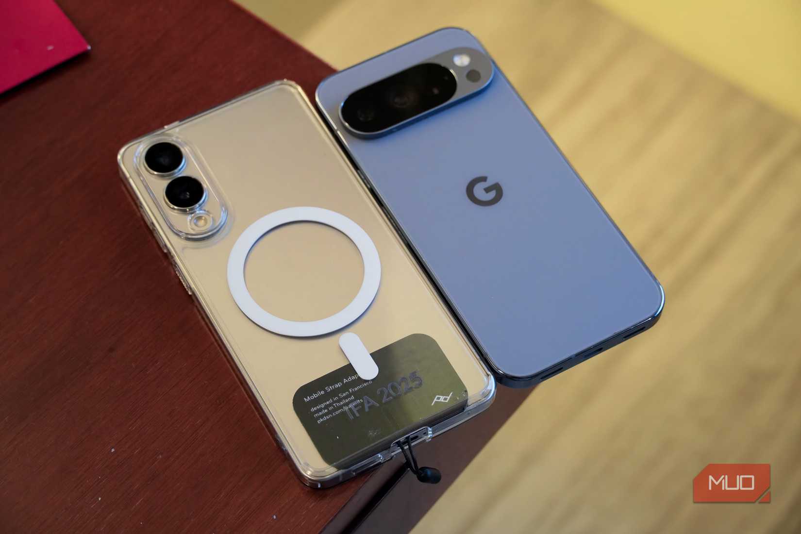 Qi2 with a case on a Galaxy phone next to a Pixel with Qi2 built-in.