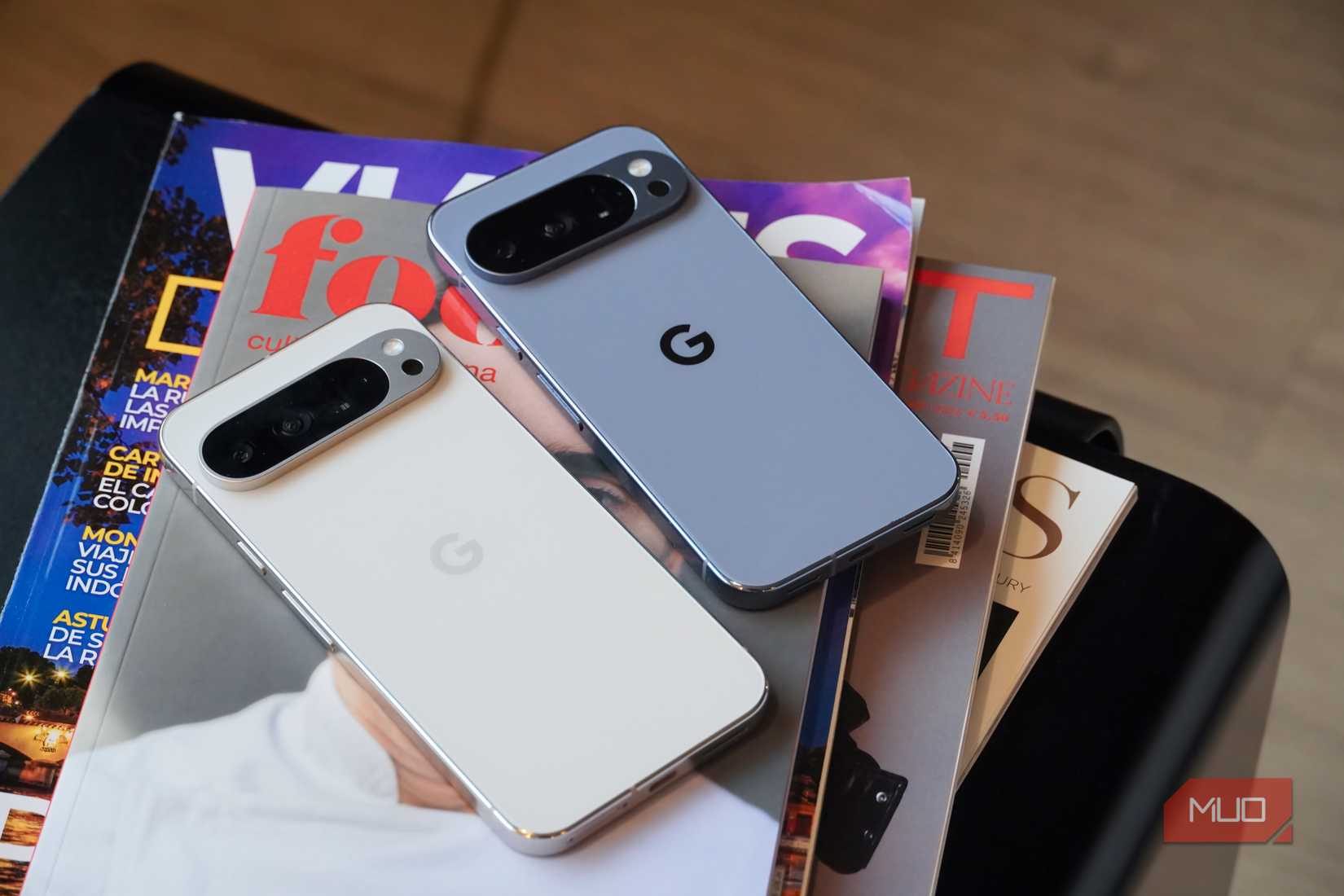The Google Pixel 9 Pro XL and Pixel 10 Pro on a stack of magazines.