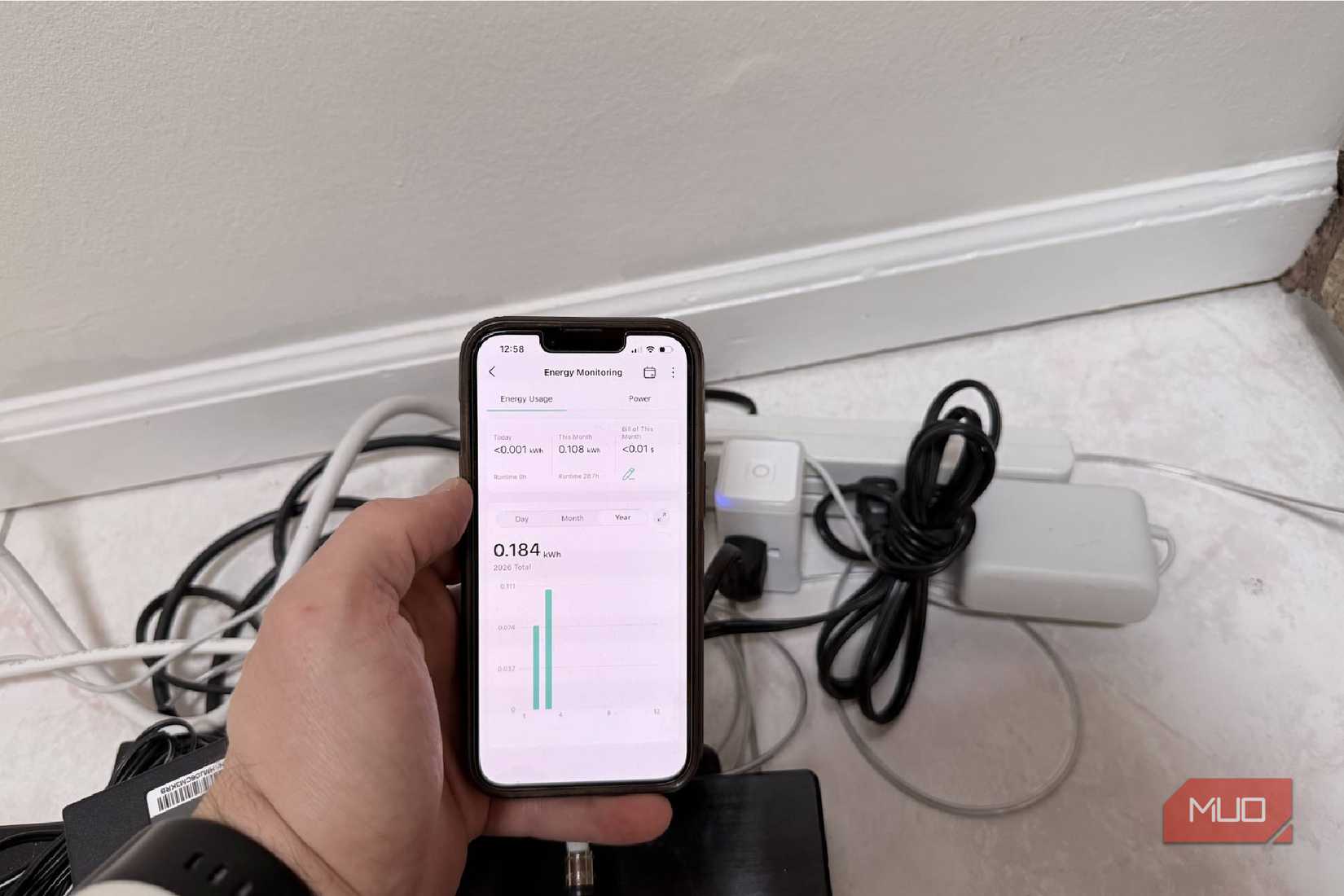 A Kasa smart plug with showing energy data from a smart TV
