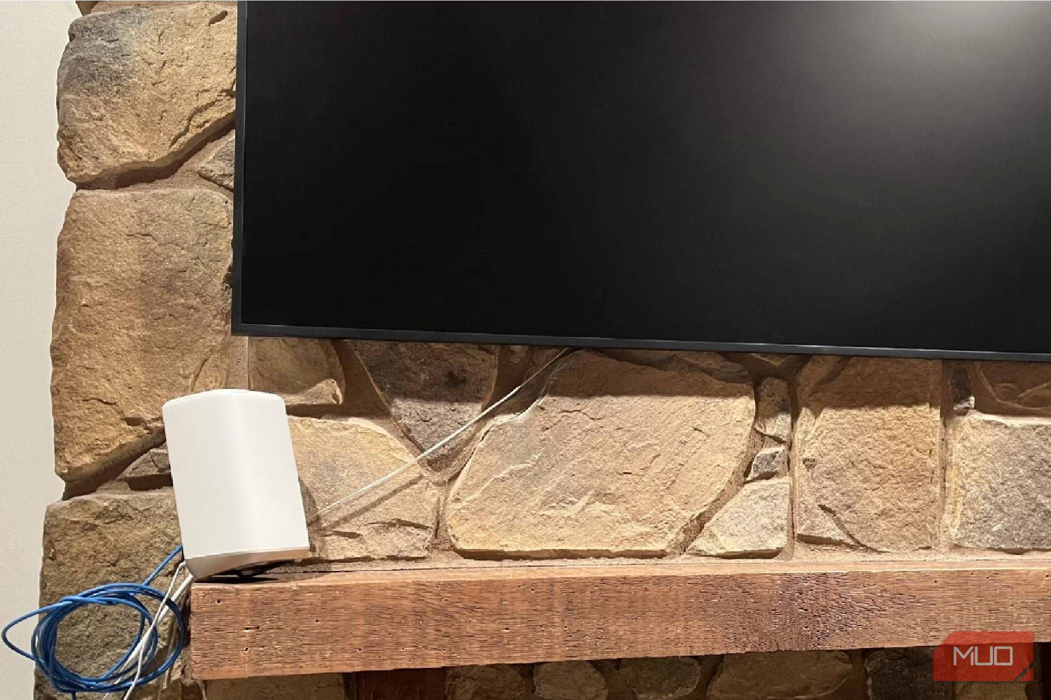 An Xfinity router under a TV on a mantle