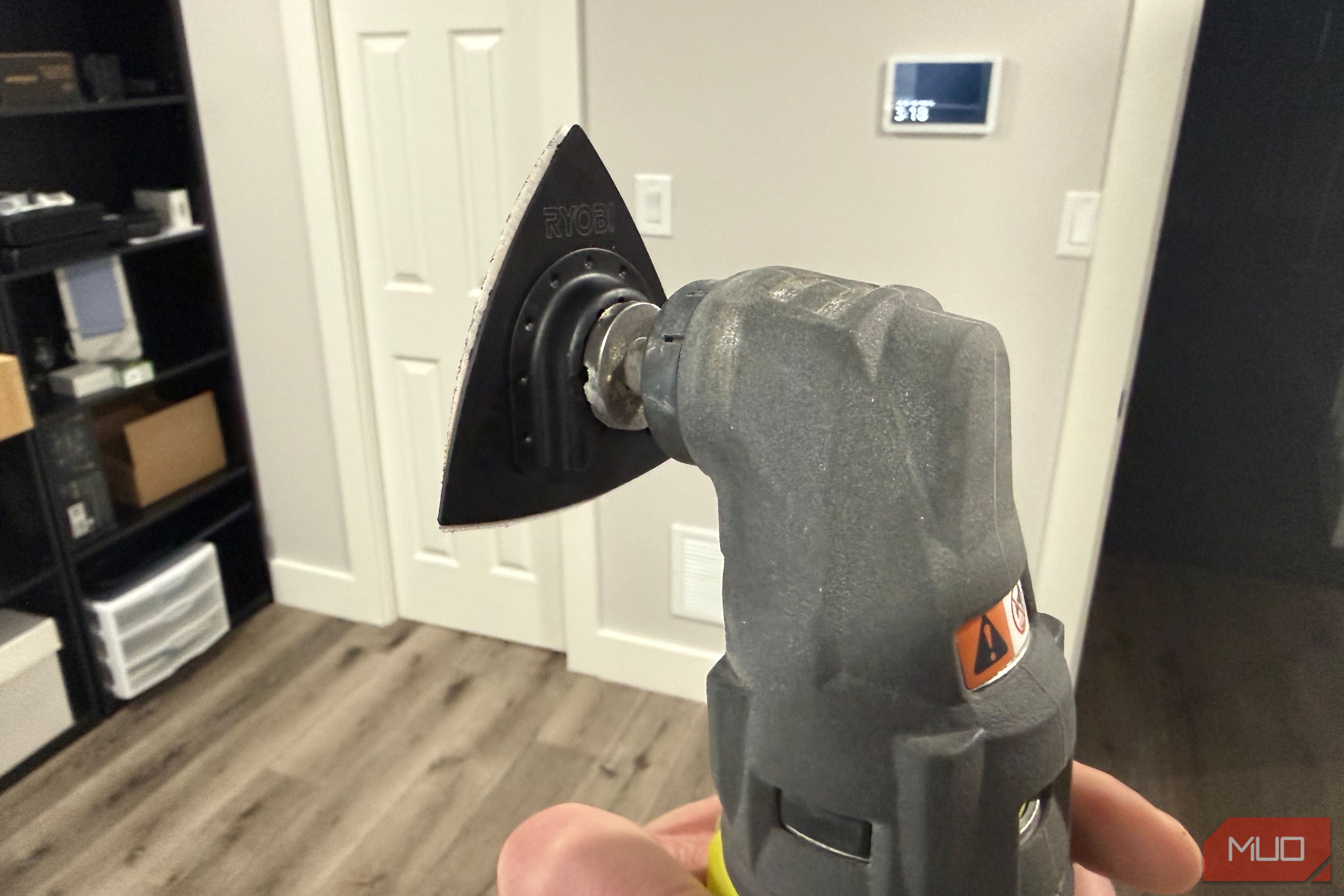 Ryobi oscillating tool with sanding attachment rear in hand