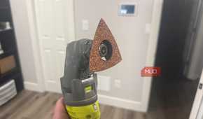 Ryobi oscillating tool with sanding attachment side