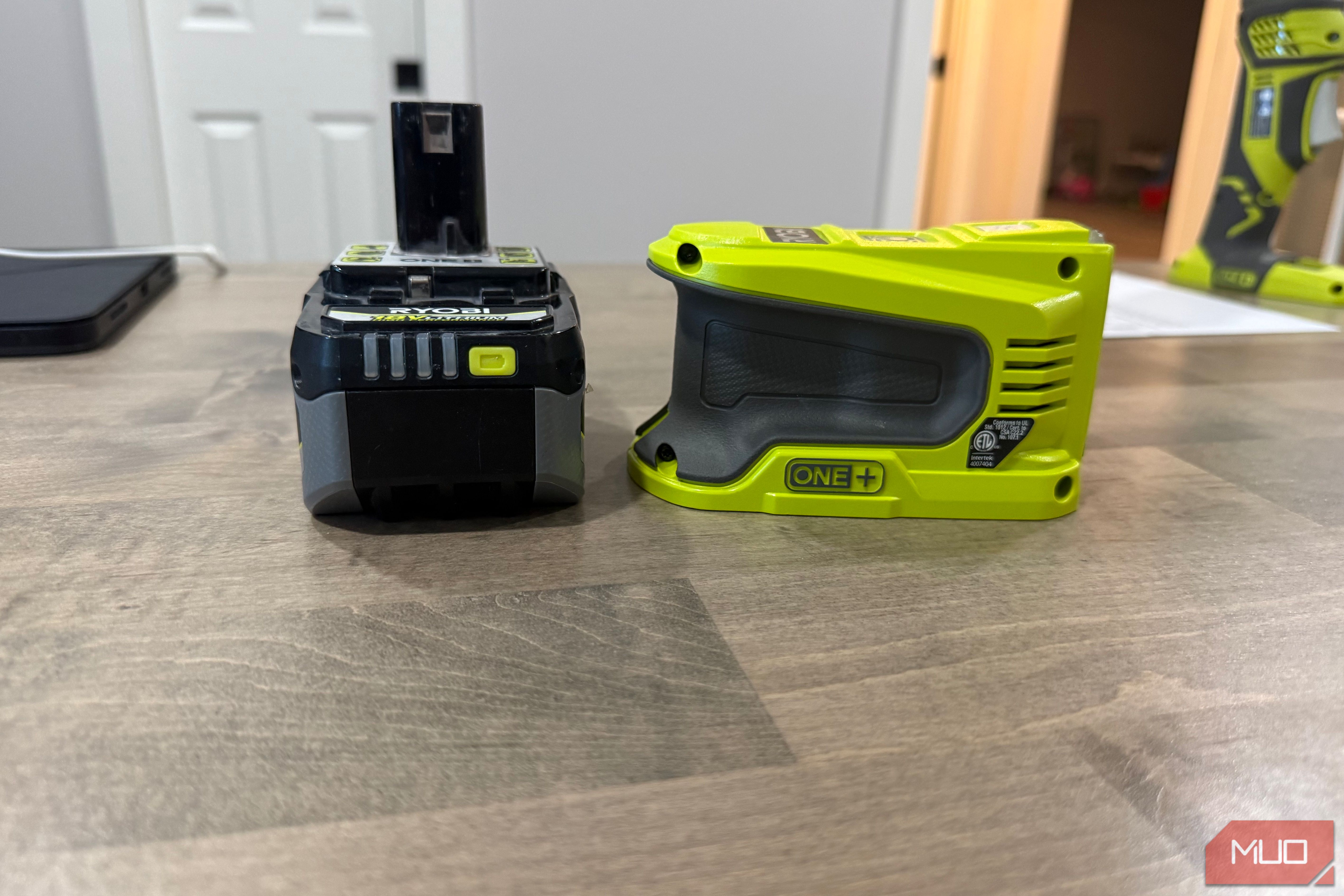ryobi power source next to battery side view