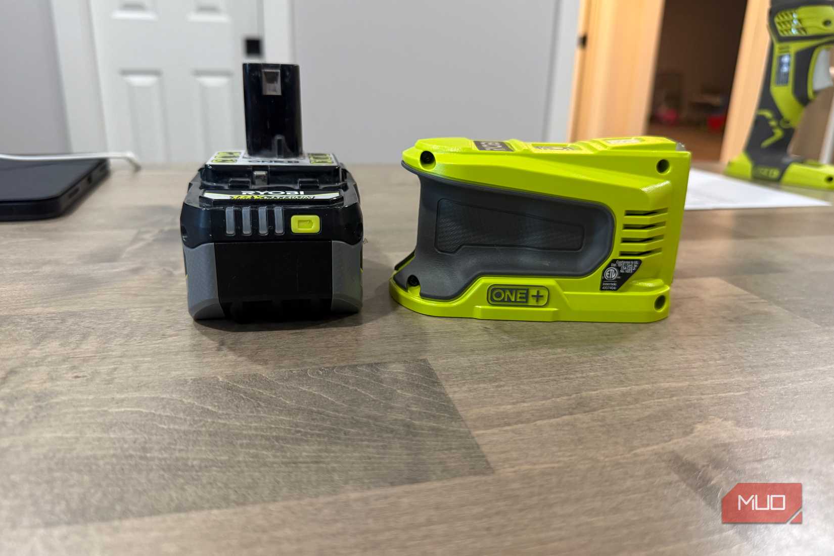 ryobi power source next to battery side view