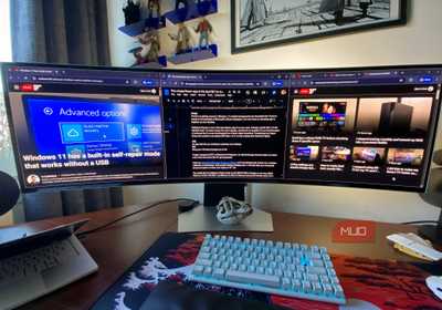A Samsung Odyssey OLED G9 monitor displaying Google Chrome tabs