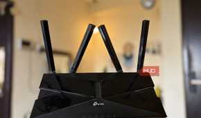 TP-Link Wi-Fi 6 router full body with antennas in hand