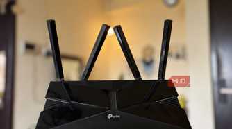 TP-Link Wi-Fi 6 router full body with antennas in hand