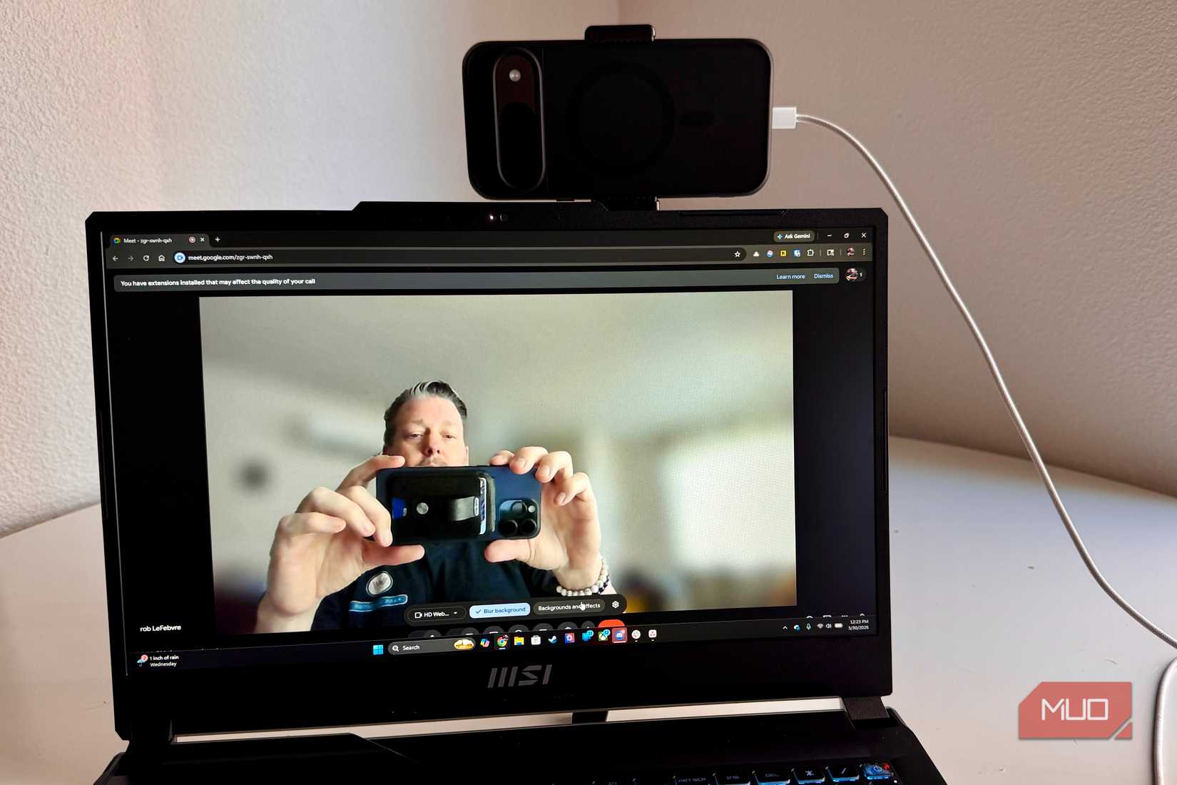Person taking a picture of a webcam on PC