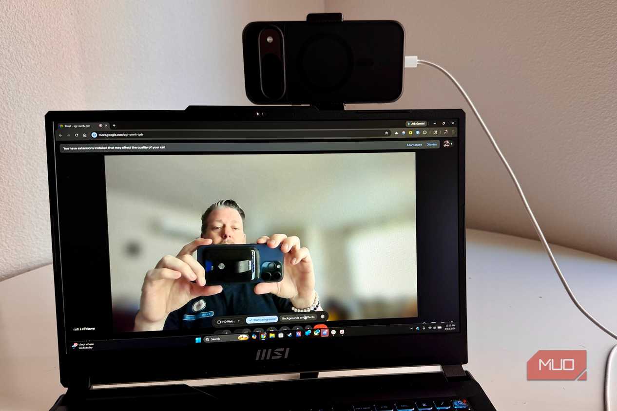 Person taking a picture of a webcam on PC