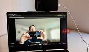 Person taking a picture of a webcam on PC
