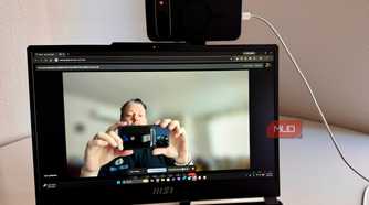 Person taking a picture of a webcam on PC