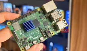 A Raspberry Pi 4 held in front of a smart TV