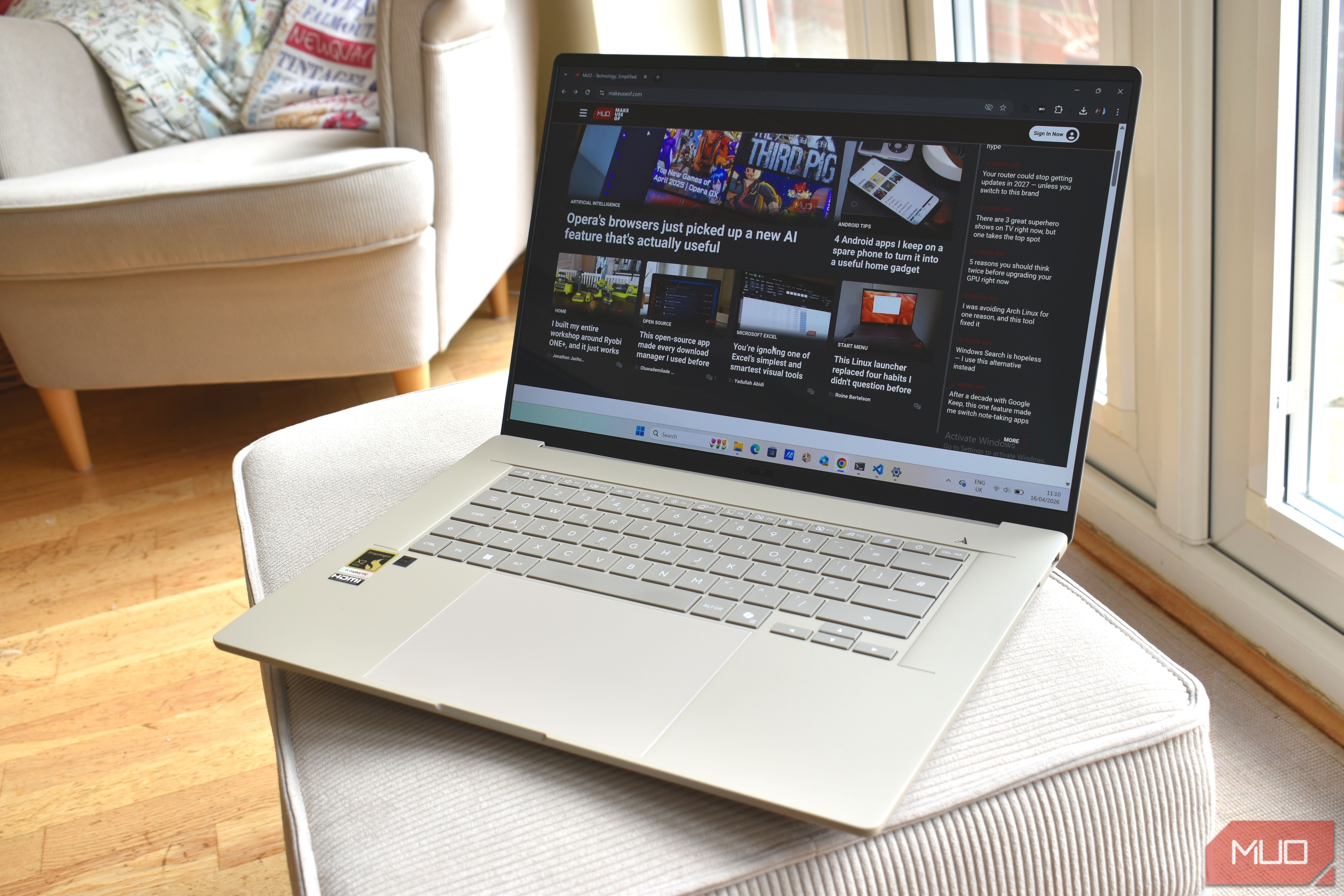asus zenbook a16 on sofa cushion.