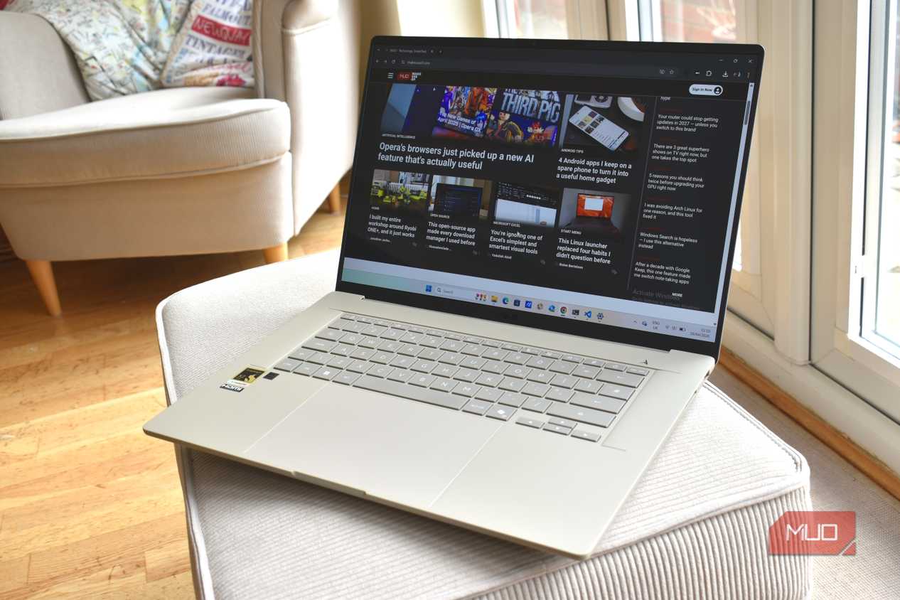 asus zenbook a16 on sofa cushion.