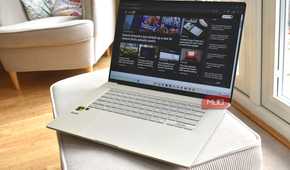 asus zenbook a16 on sofa cushion.