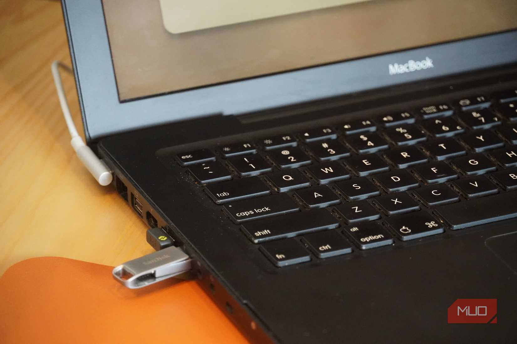 A ChromeOS Flex USB drive plugged into a MacBook.