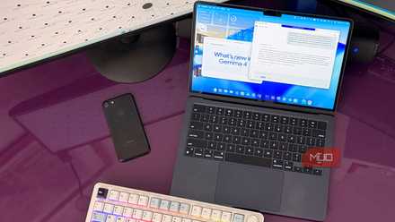 Dual monitors, laptop, and a mechanical keyboard on a desk showing a local LLM with Gemma 4