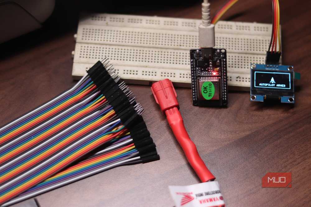 An ESP32 with an OLED display and breadboard for prototyping network projects