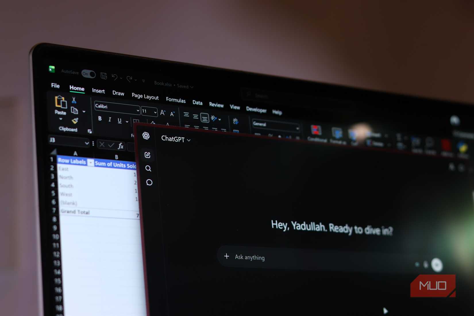 Excel and ChatGPT open on Windows 11 laptop.