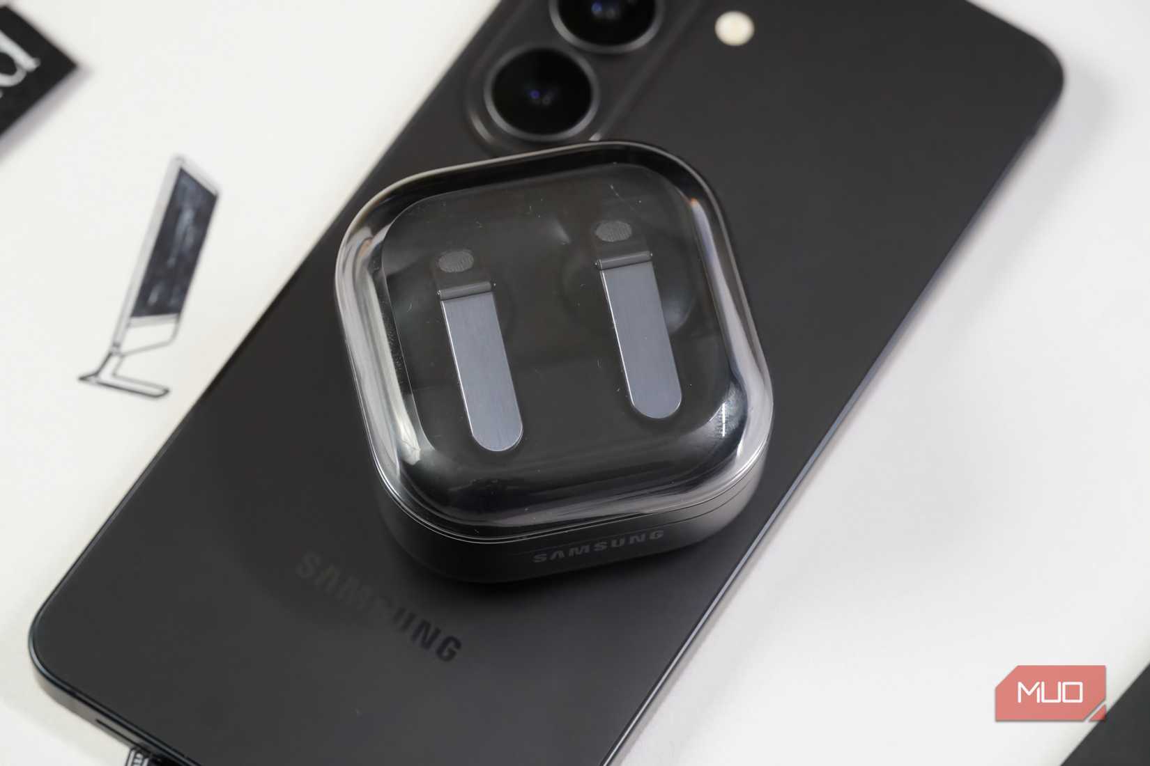 Samsung Galaxy Buds atop a Galaxy phone.