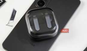 Samsung Galaxy Buds atop a Galaxy phone.