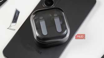 Samsung Galaxy Buds atop a Galaxy phone.