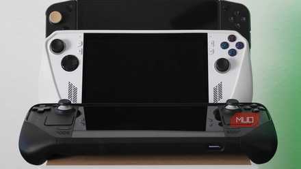 PC gaming handhelds resting on a speaker.