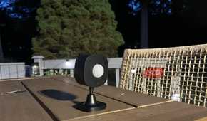 A Govee Outdoor Motion Sensor on a table