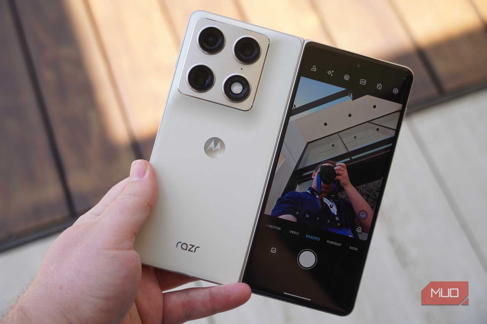 The Motorola Razr Fold in the hand with the cover screen preview on.
