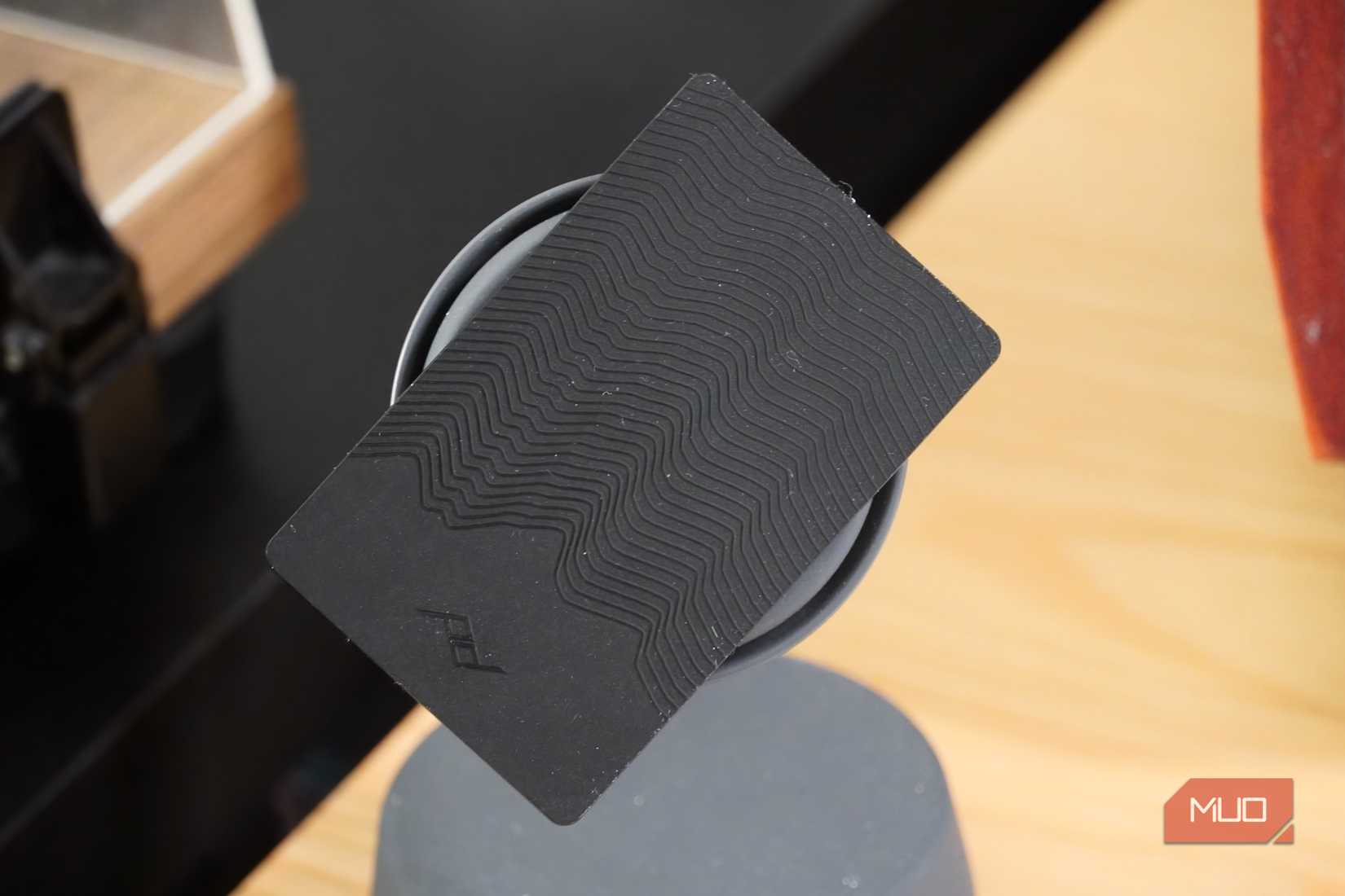 The Peak Design tracker on a MagSafe charger.