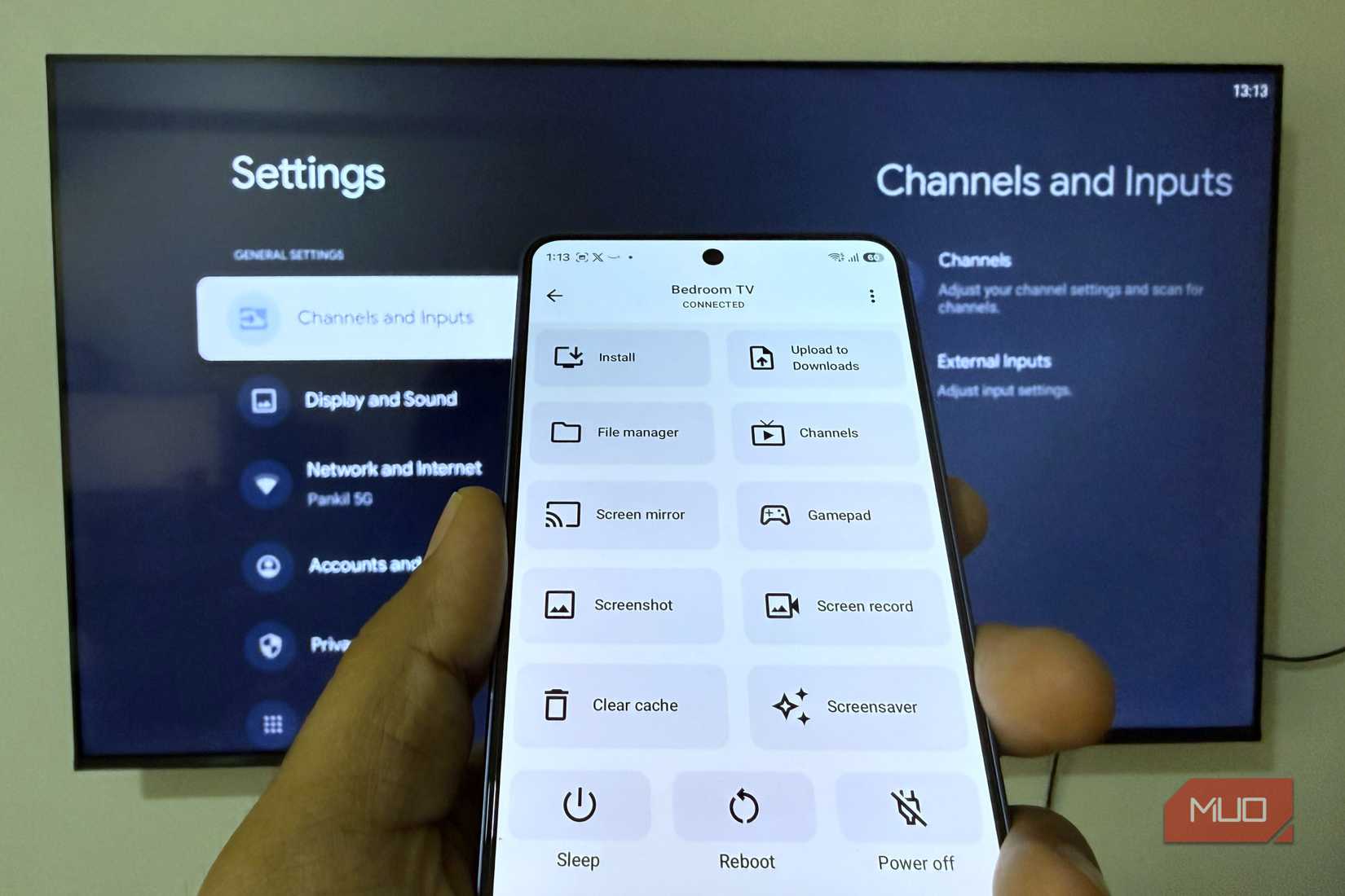 Phone showing atvTools app in front of a TV