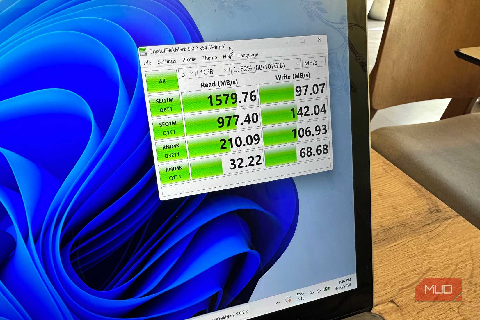 Photo of a Windows laptop with the speed test results of an SSD