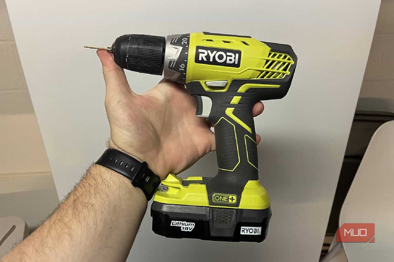 A RYOBI ONE holding in front of a fridge
