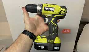 A RYOBI ONE holding in front of a fridge