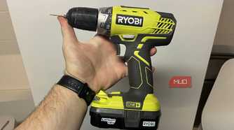 A RYOBI ONE holding in front of a fridge