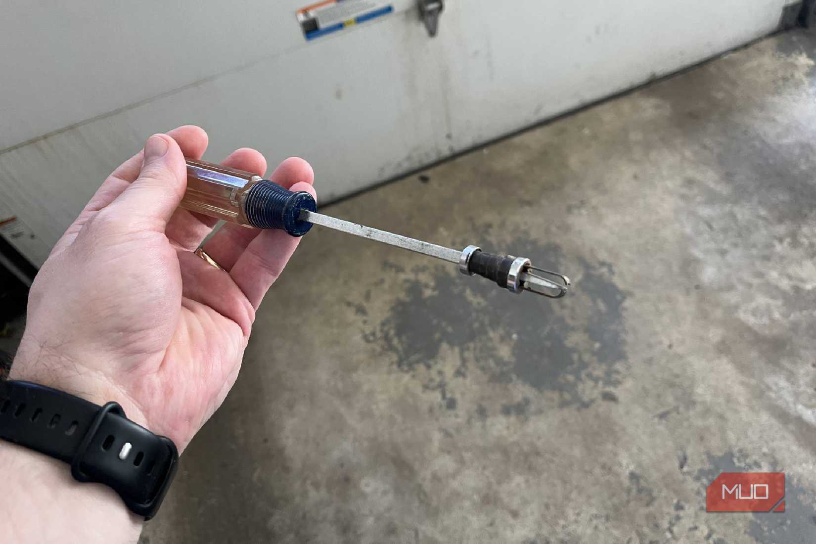 A screw-holding addition on the tip of a flathead screwdriver