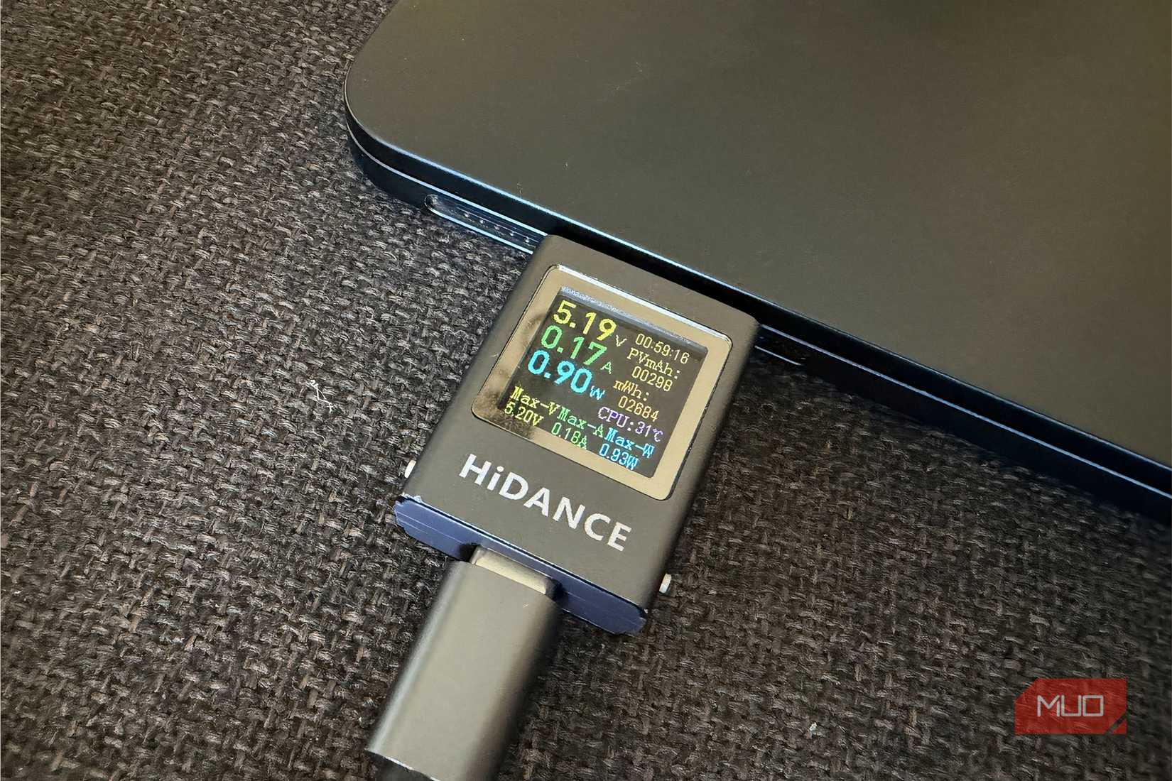 Type-C voltage ammeter connected to MacBook showing the watts used