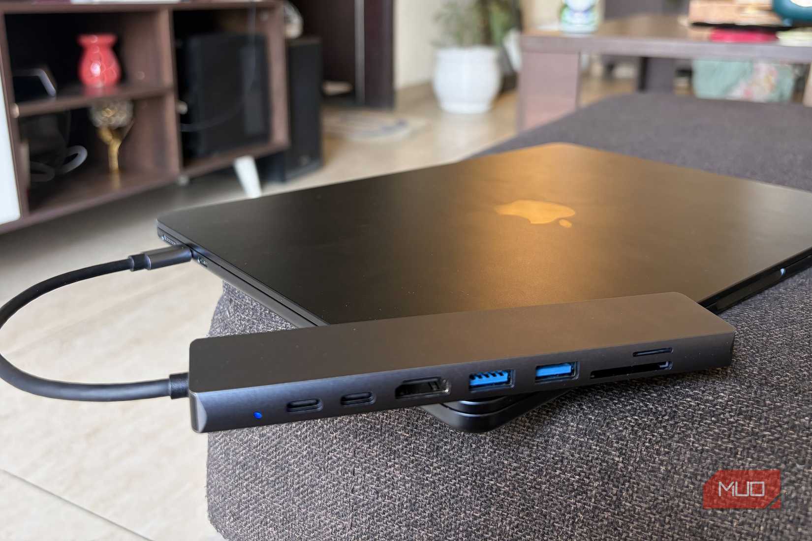 USB-C hub connected directly to a MacBook and kept on sofa