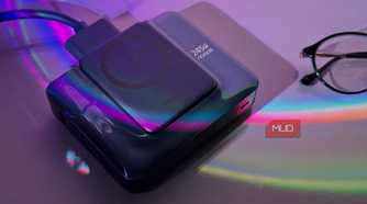 wireless charging pad and power bank with colorful light refraction on purple background next to glasses
