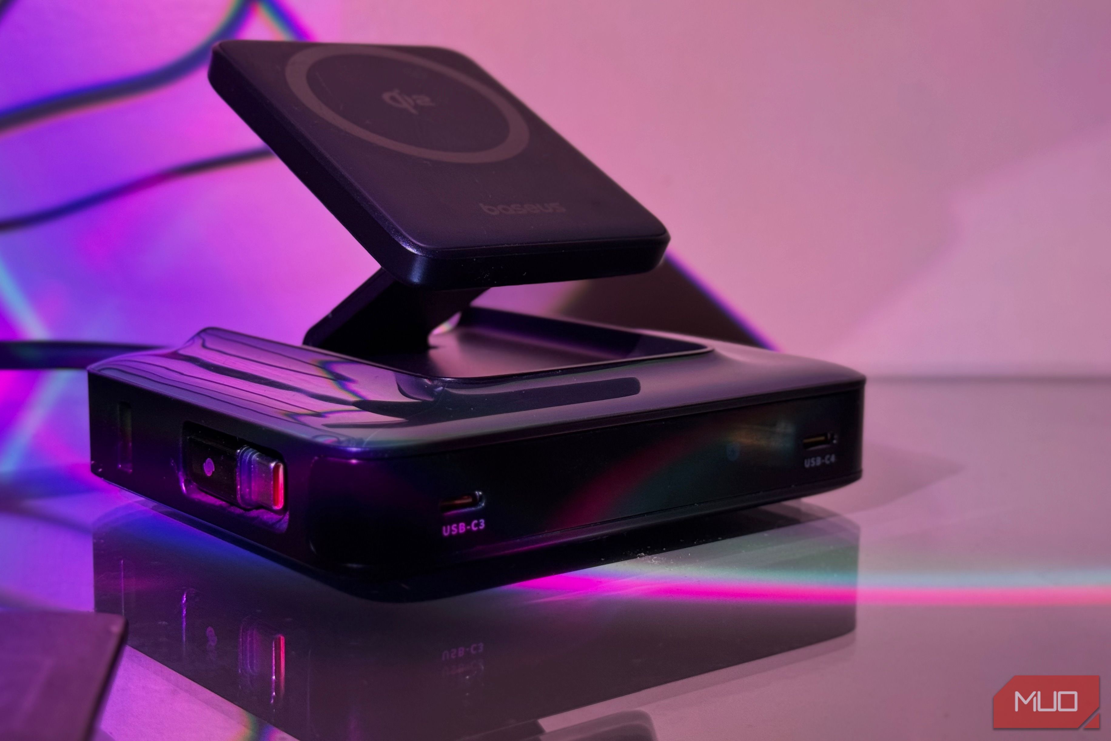 wireless charging pad on black charging dock with purple neon lighting
