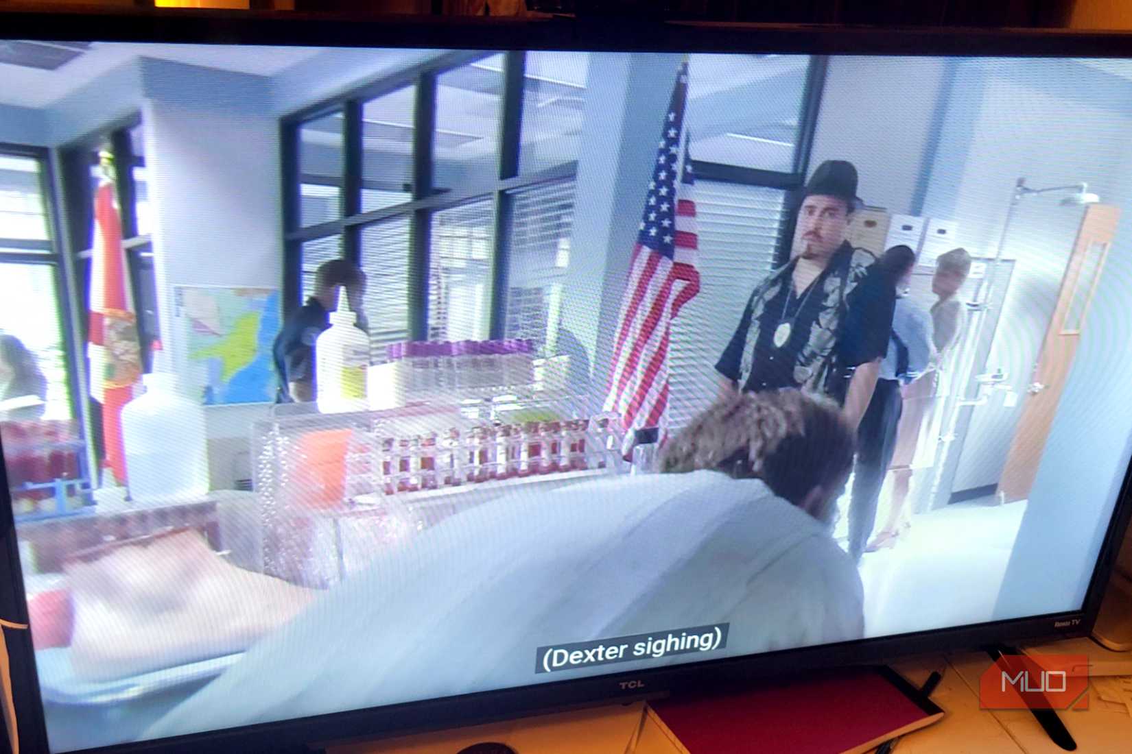 A Roku TV showing captions during a Dexter episode