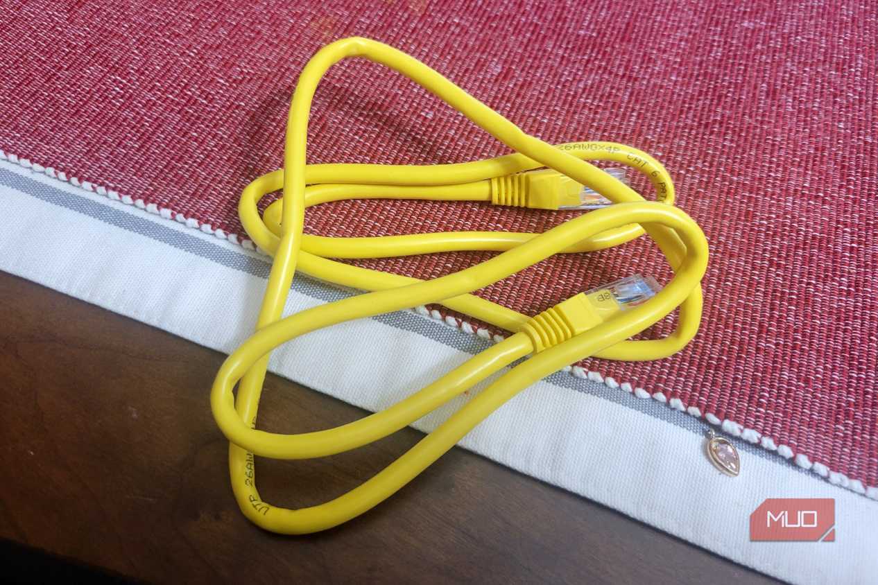 A whole Ethernet cable on a red and white rug thing