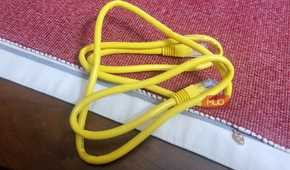 A whole Ethernet cable on a red and white rug thing