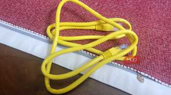 A whole Ethernet cable on a red and white rug thing