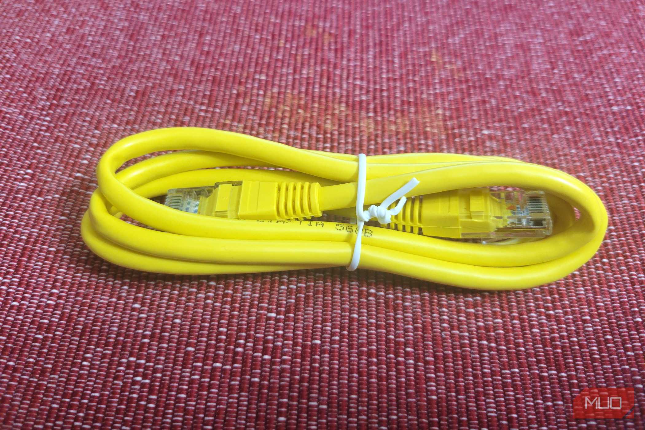 A yellow generic Ethernet cable tied up