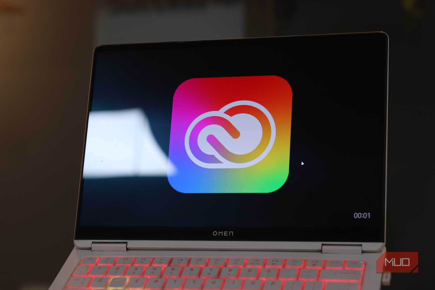 Adobe Creative Cloud logo on laptop screen.